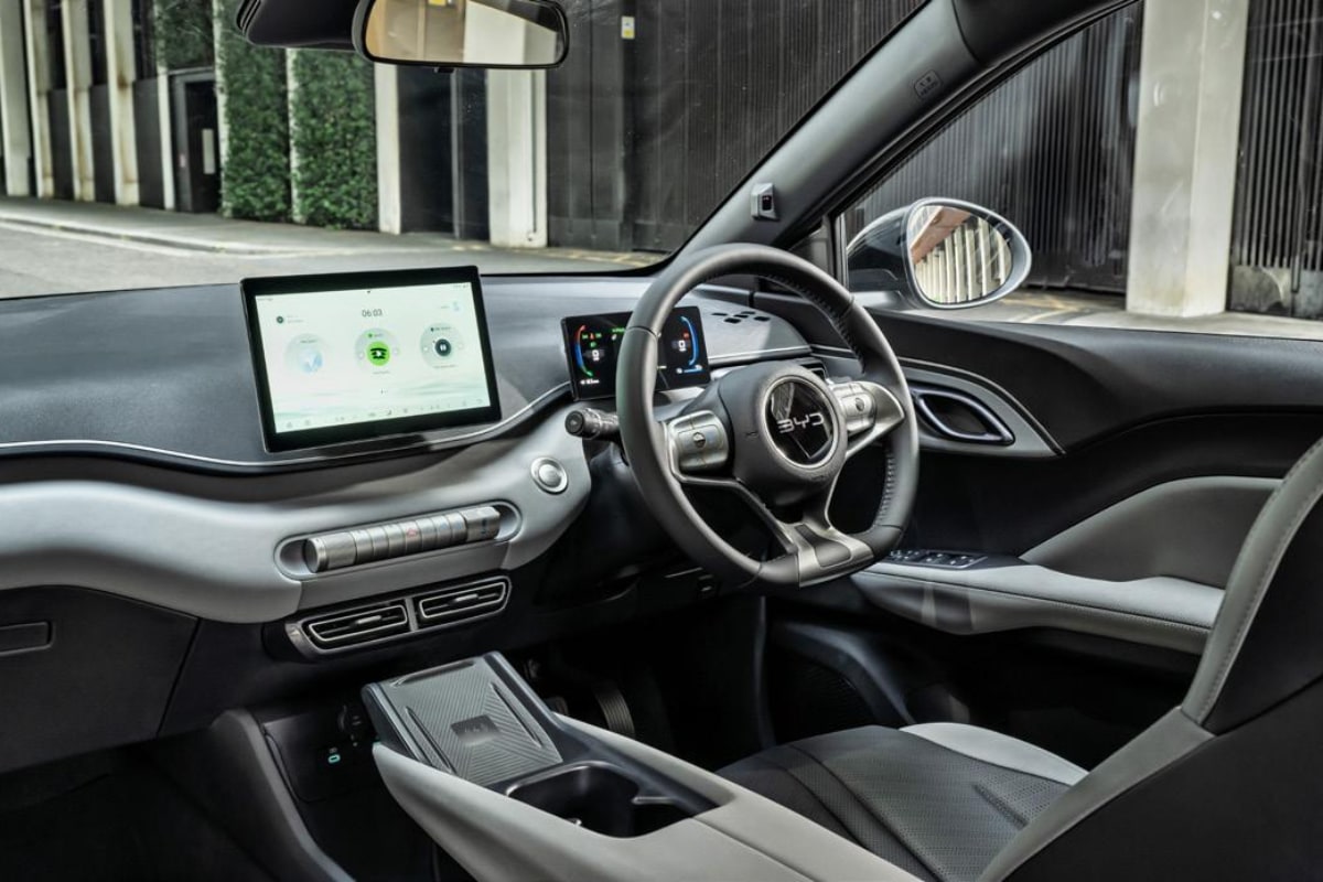 BYD Dolphin interior with sleek design, touchscreen, and ergonomic steering, ideal for chauffeurs.