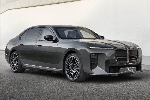 Modern luxury electric sedan with sleek design, large alloy wheels, and distinctive front grille, ideal for professional drivers and executive transport.